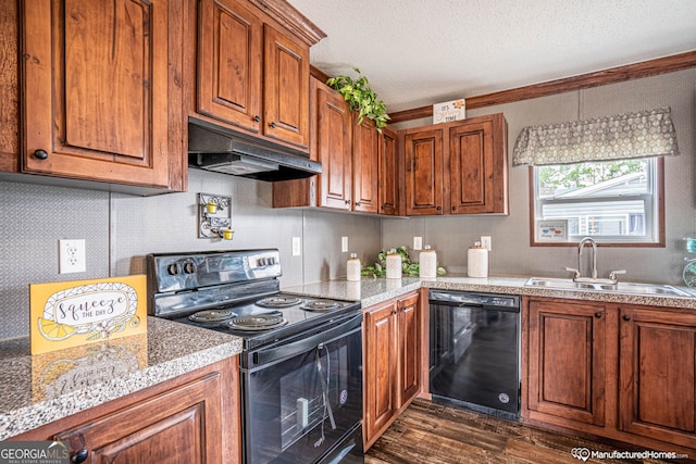 kitchen featuring black appliances, dark hardwood / wood-style flooring, sink, and a textured ceiling