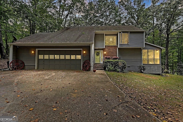 view of front of property with a garage and a front lawn