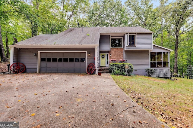 view of front facade with a garage, a sunroom, and a front yard