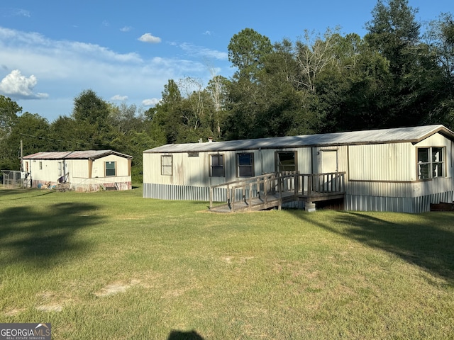 rear view of house featuring a yard