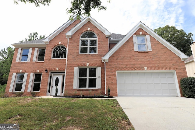 view of front of home with a front yard and a garage