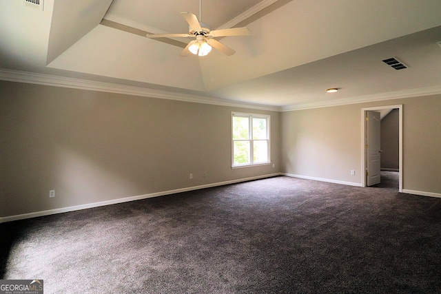 carpeted empty room featuring ceiling fan, a raised ceiling, and crown molding