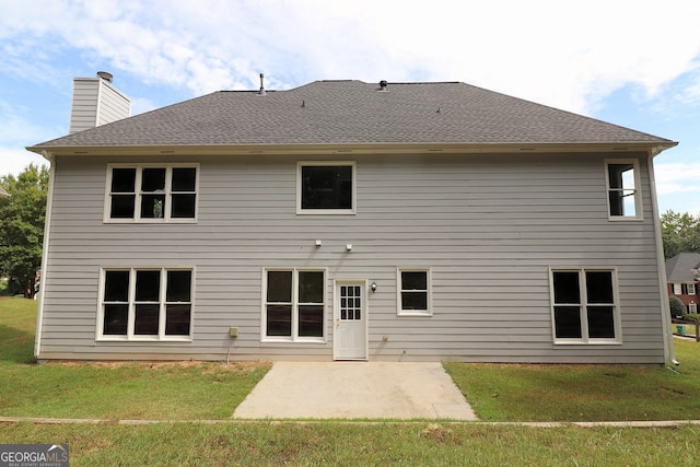 rear view of house featuring a patio area and a yard