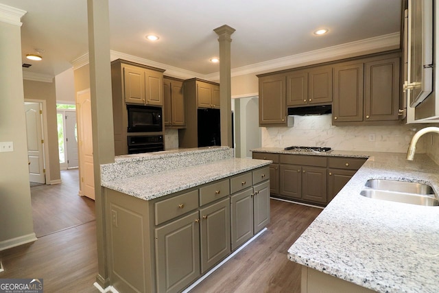 kitchen featuring a center island, black appliances, sink, and dark hardwood / wood-style floors