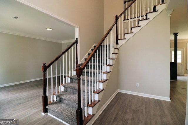 staircase featuring hardwood / wood-style flooring and ornamental molding