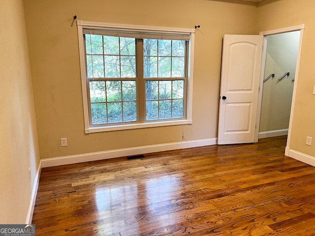 empty room with hardwood / wood-style floors