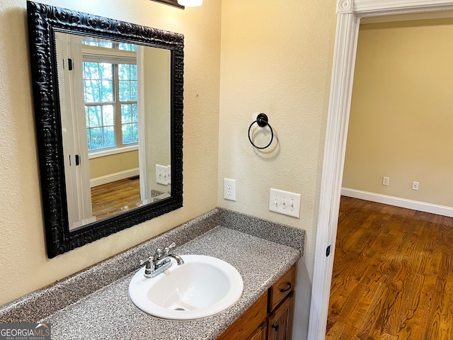 bathroom with vanity and hardwood / wood-style flooring