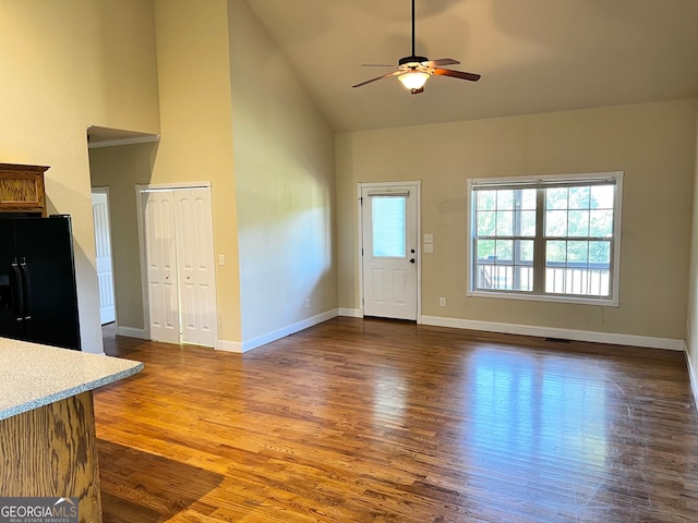 unfurnished living room featuring ceiling fan, hardwood / wood-style floors, and high vaulted ceiling