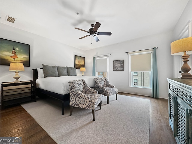 bedroom with dark wood-type flooring and ceiling fan