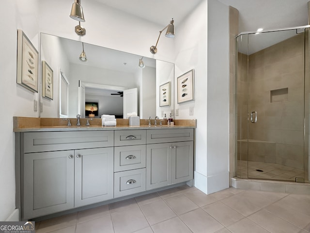 bathroom with vanity, a shower with shower door, ceiling fan, and tile patterned floors