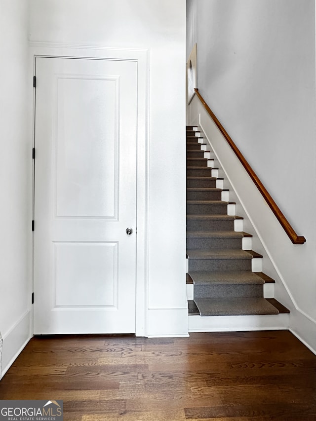 staircase with hardwood / wood-style flooring