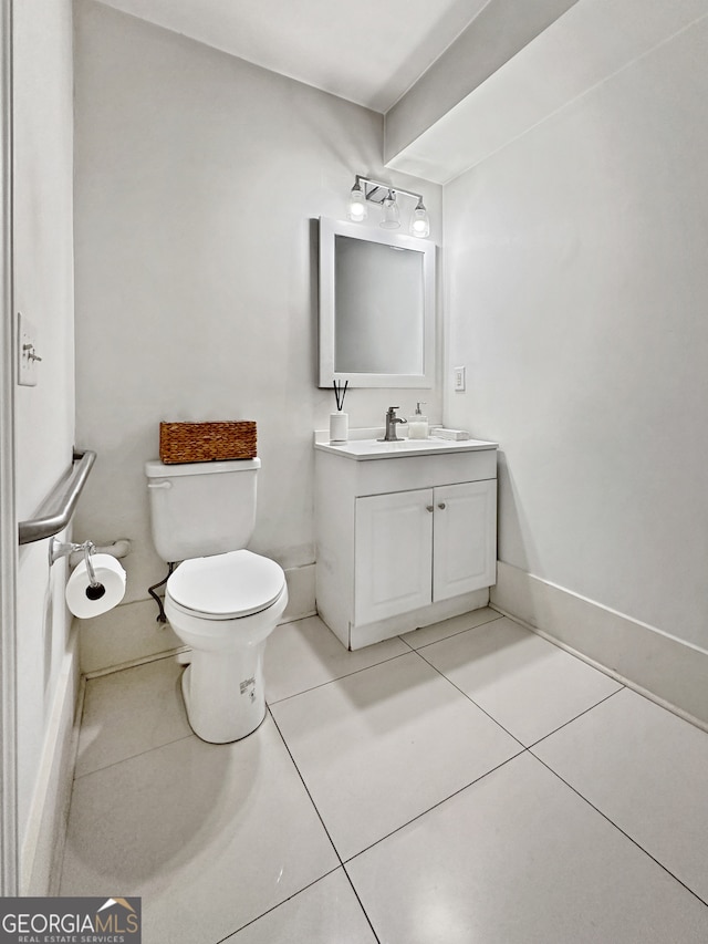 bathroom with tile patterned floors, toilet, and vanity