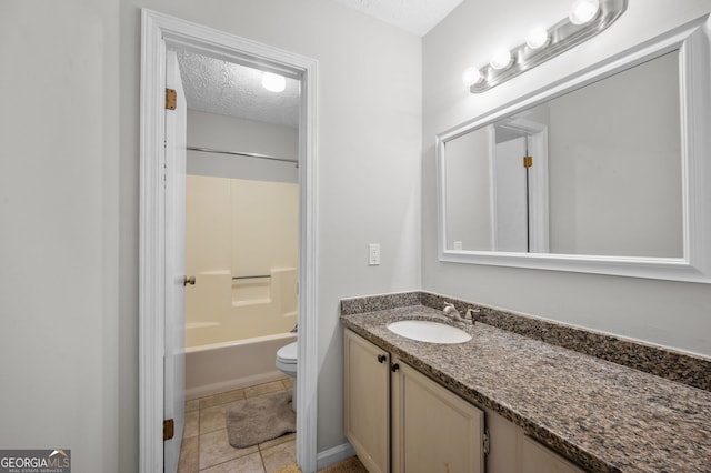 full bathroom with tile patterned floors, a textured ceiling, vanity, and toilet