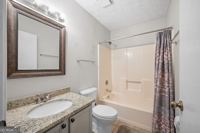 full bathroom with vanity, a textured ceiling, shower / bath combo with shower curtain, tile patterned floors, and toilet