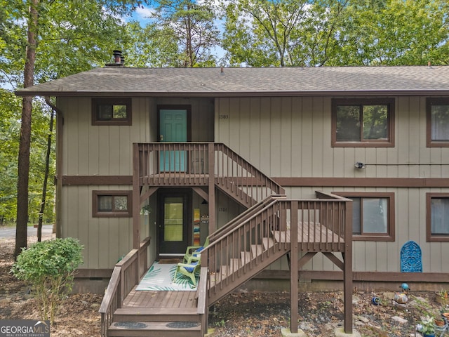 rear view of house with a wooden deck