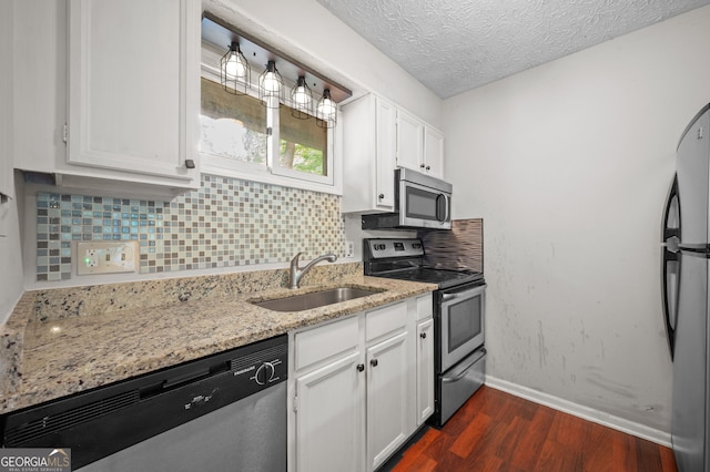 kitchen with white cabinetry, appliances with stainless steel finishes, tasteful backsplash, and sink