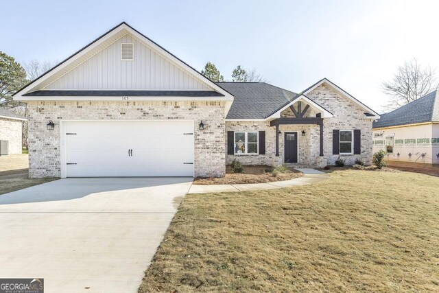 craftsman inspired home with a front yard and a garage