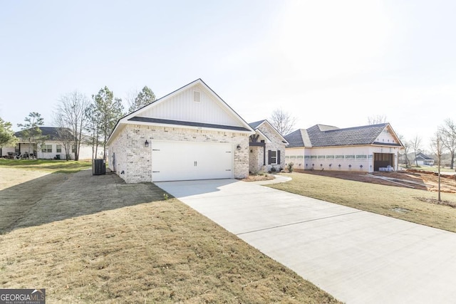 view of front of home featuring a garage, a front lawn, and central air condition unit