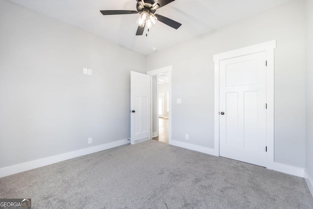 unfurnished bedroom featuring ceiling fan and carpet flooring