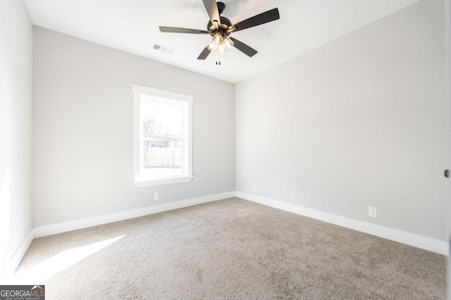 spare room with carpet and ceiling fan