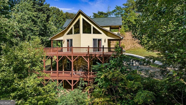 back of house featuring a wooden deck