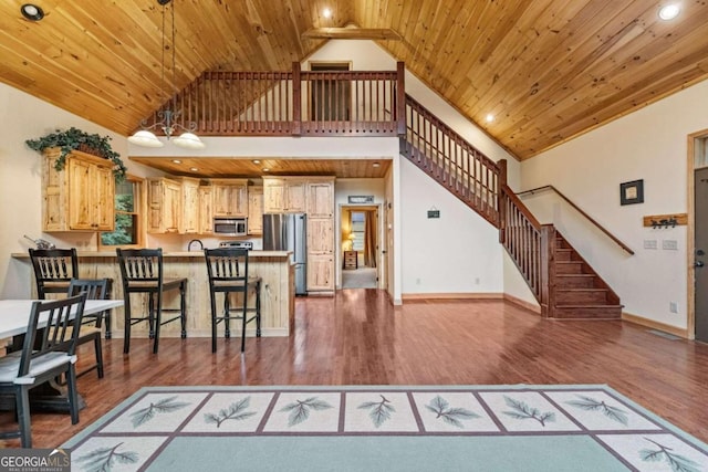 living room with dark hardwood / wood-style flooring, high vaulted ceiling, and wood ceiling