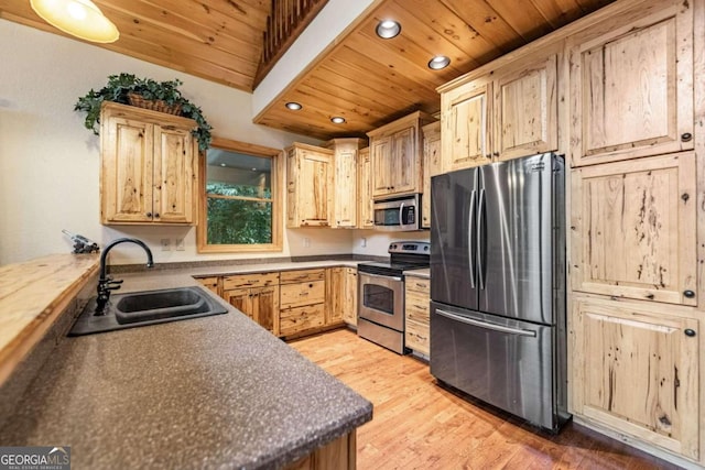 kitchen with wood ceiling, sink, light wood-type flooring, and appliances with stainless steel finishes