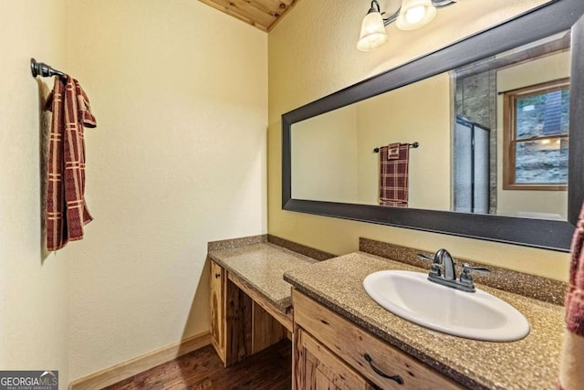 bathroom with hardwood / wood-style floors and vanity