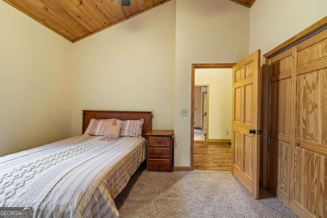 carpeted bedroom featuring ceiling fan, high vaulted ceiling, and wooden ceiling