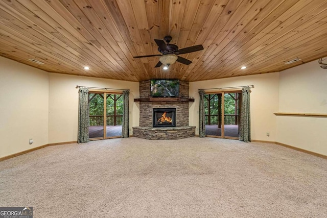 unfurnished living room with carpet floors, a healthy amount of sunlight, and wood ceiling