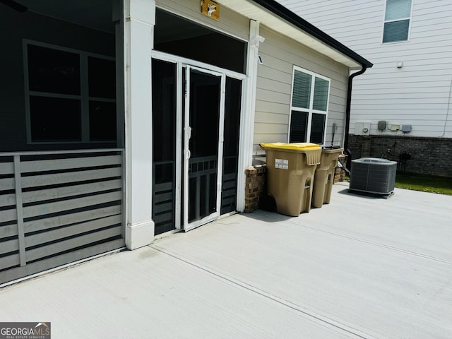 view of patio with central AC unit and a wooden deck