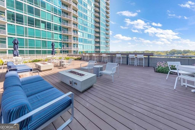 wooden deck with an outdoor fire pit