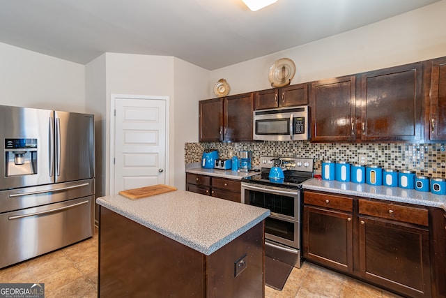 kitchen featuring decorative backsplash, dark brown cabinetry, appliances with stainless steel finishes, and a kitchen island