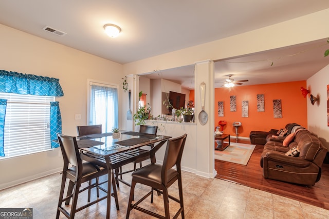 dining area with light hardwood / wood-style floors and ceiling fan