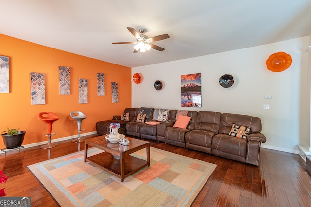 living room featuring ceiling fan and hardwood / wood-style flooring