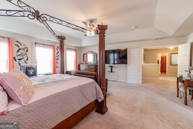 bedroom featuring a tray ceiling, ceiling fan, and light colored carpet