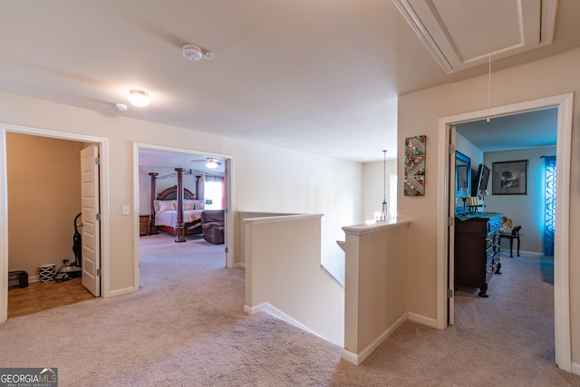 hallway featuring light colored carpet