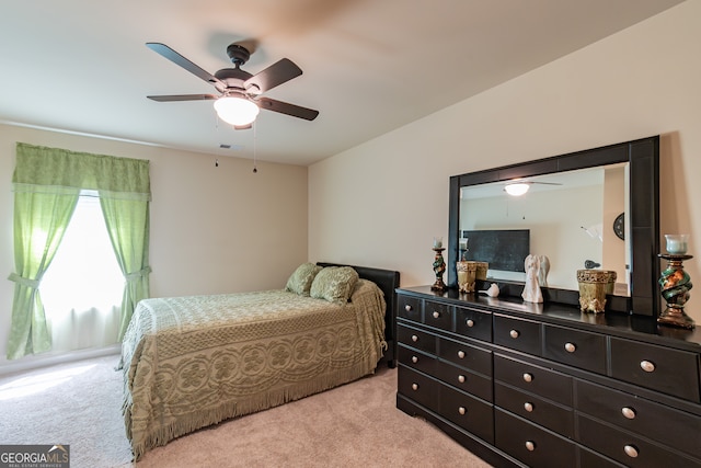 bedroom featuring light carpet and ceiling fan