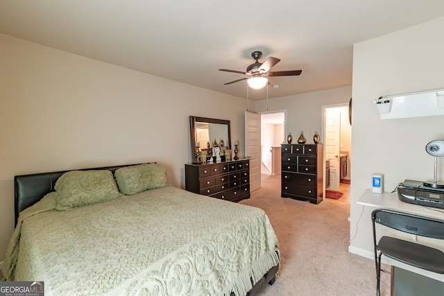 bedroom featuring ceiling fan, light carpet, and ensuite bathroom