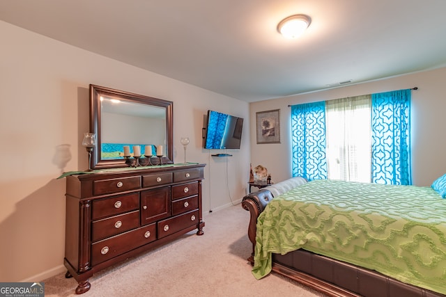 bedroom featuring light carpet