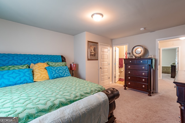 carpeted bedroom featuring connected bathroom