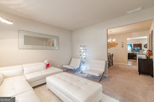 carpeted living room with a notable chandelier