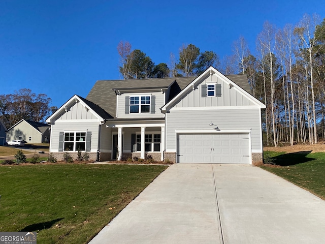 craftsman house with a front yard, a garage, and covered porch