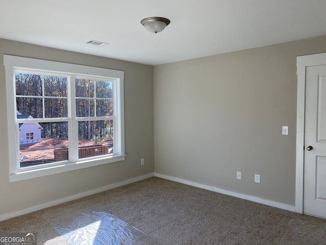 spare room featuring carpet