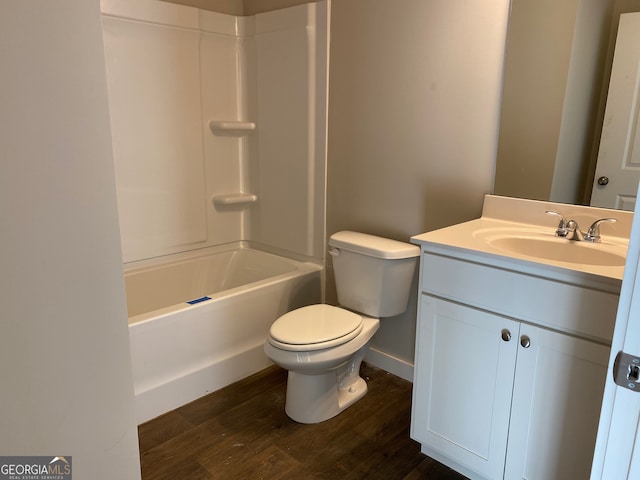 full bathroom with bathing tub / shower combination, hardwood / wood-style floors, vanity, and toilet