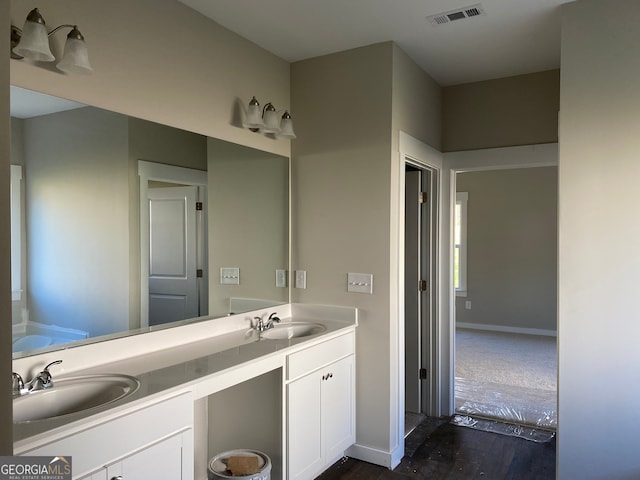 bathroom with vanity and hardwood / wood-style flooring