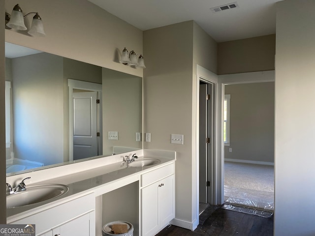 140 Westminster Ct, Winder, GA 30680 - full bathroom with double vanity, wood finished floors, and a bathtub