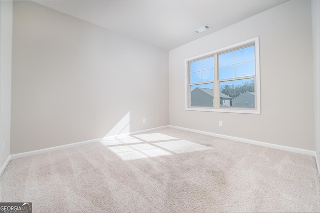 unfurnished room featuring visible vents, baseboards, and carpet