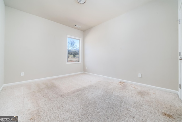 empty room with baseboards, carpet flooring, and visible vents