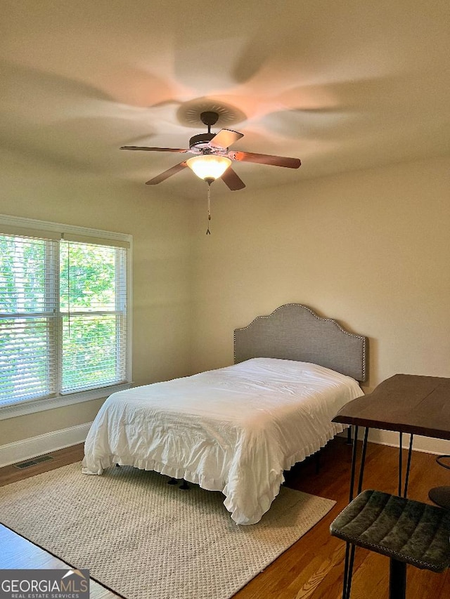 bedroom featuring wood-type flooring and ceiling fan